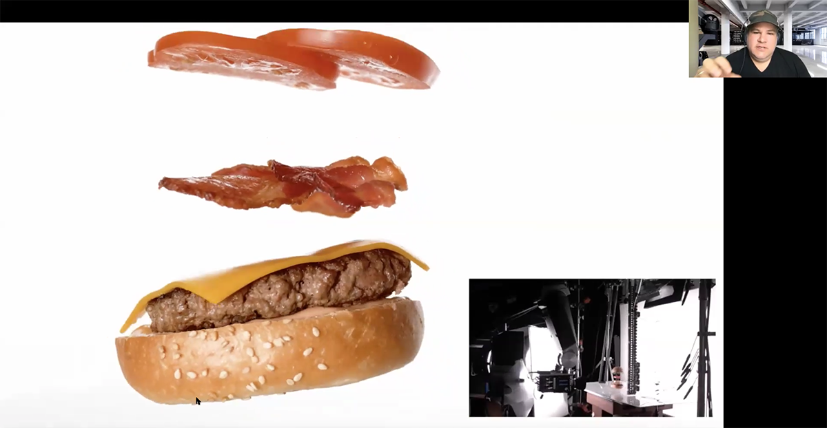 A screenshot of cheeseburger ingredients flying through the air for a photo shoot.