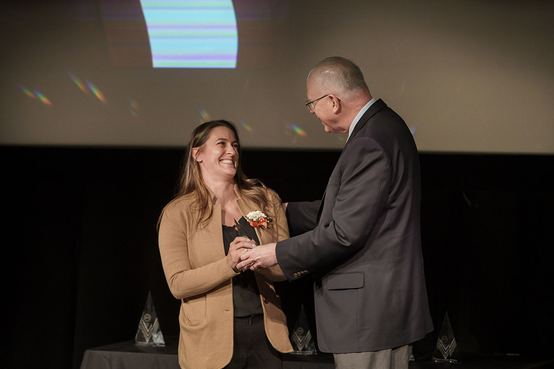 woman receiving award from President Munson.