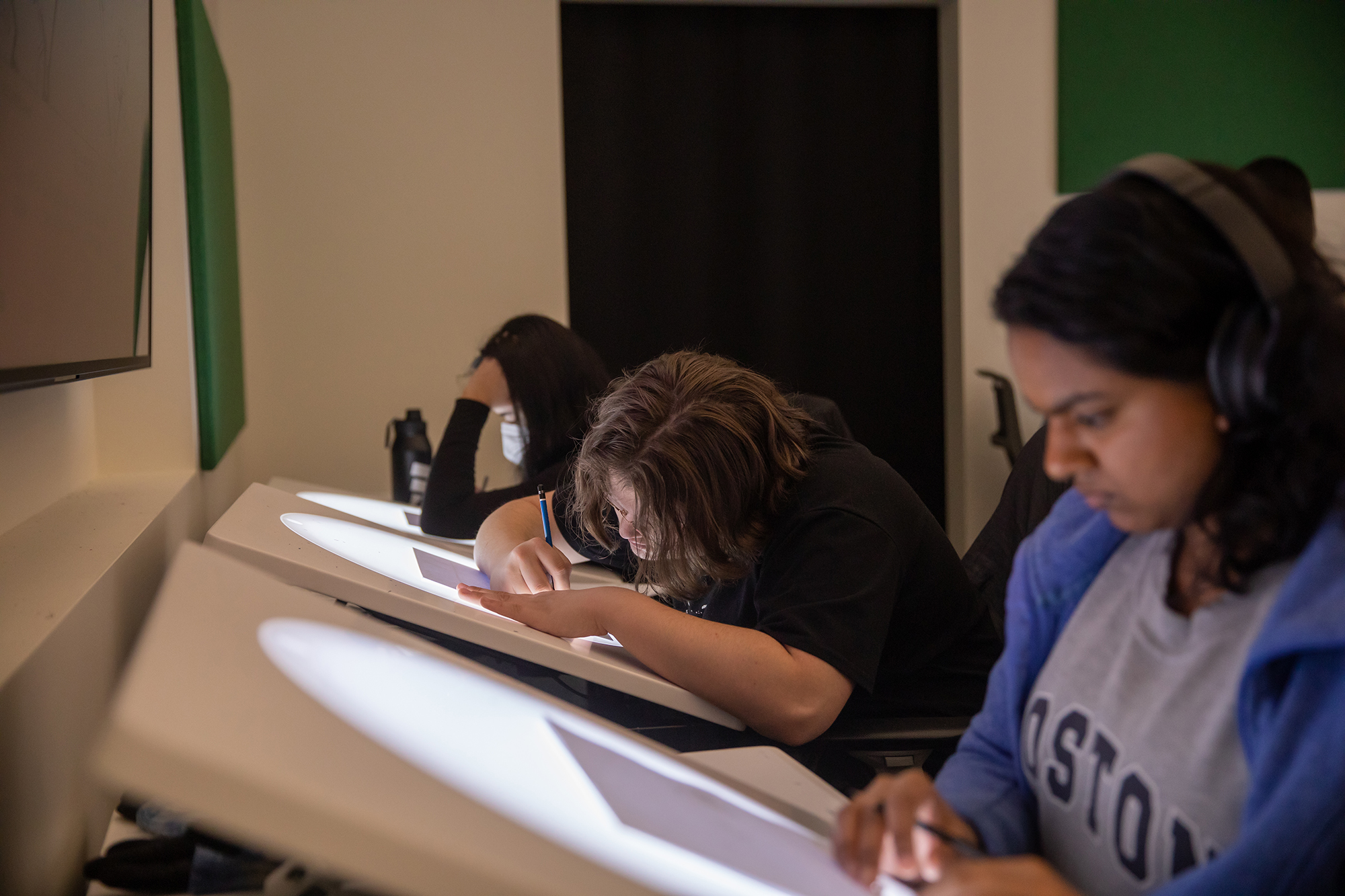 Students draw on animation light tables.