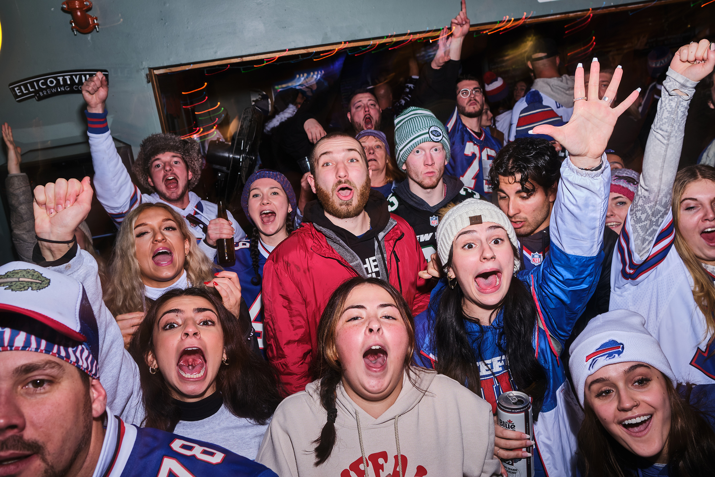 A group of fans cheer on the Bills in a bar.