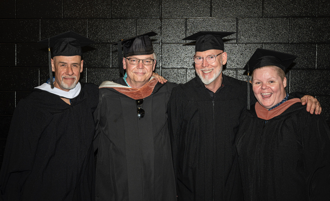 A group of faculty in regalia at the 2024 commencement ceremony.