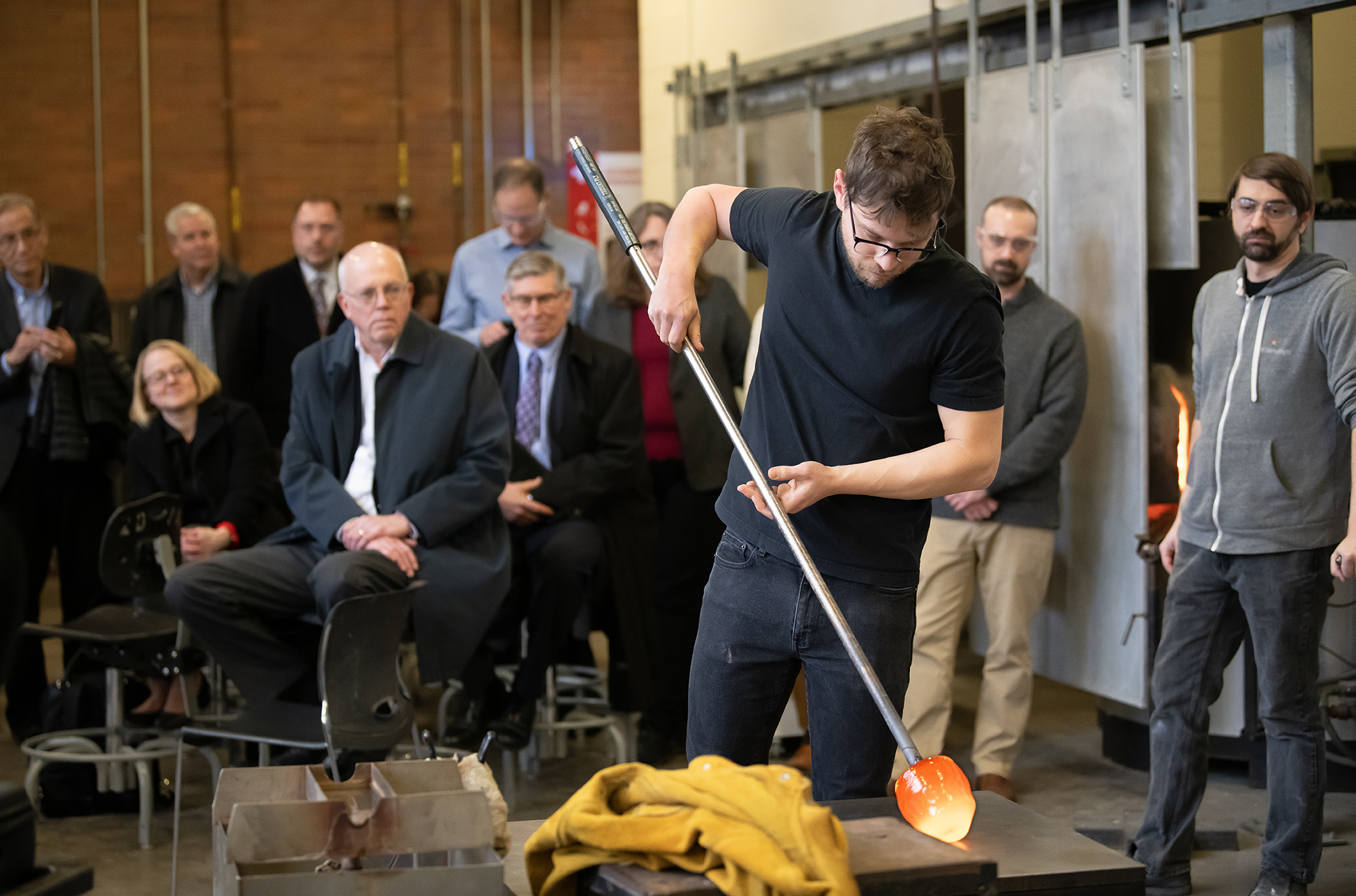 Michael Stern blows glass for an audience in the RIT hot shop.