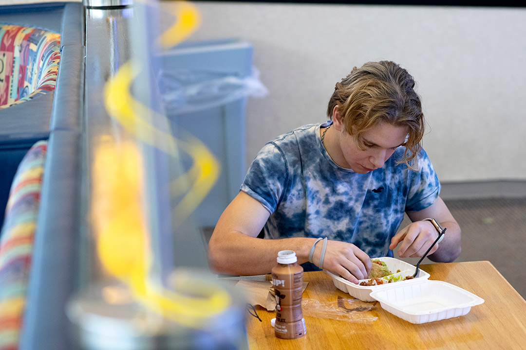 student eating at a table.