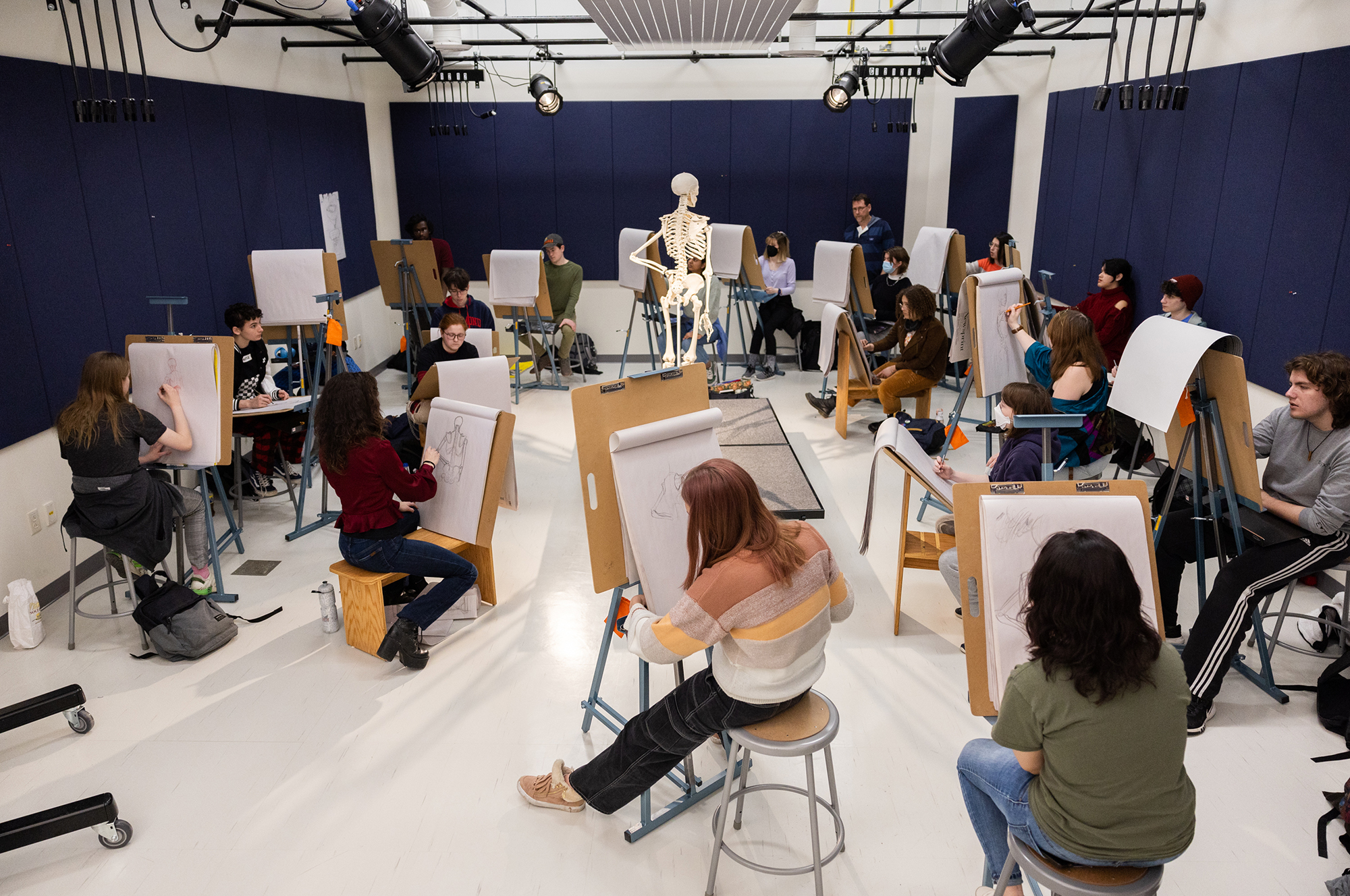 An expansive view of an animation drawing studio in which students are drawing on easels.