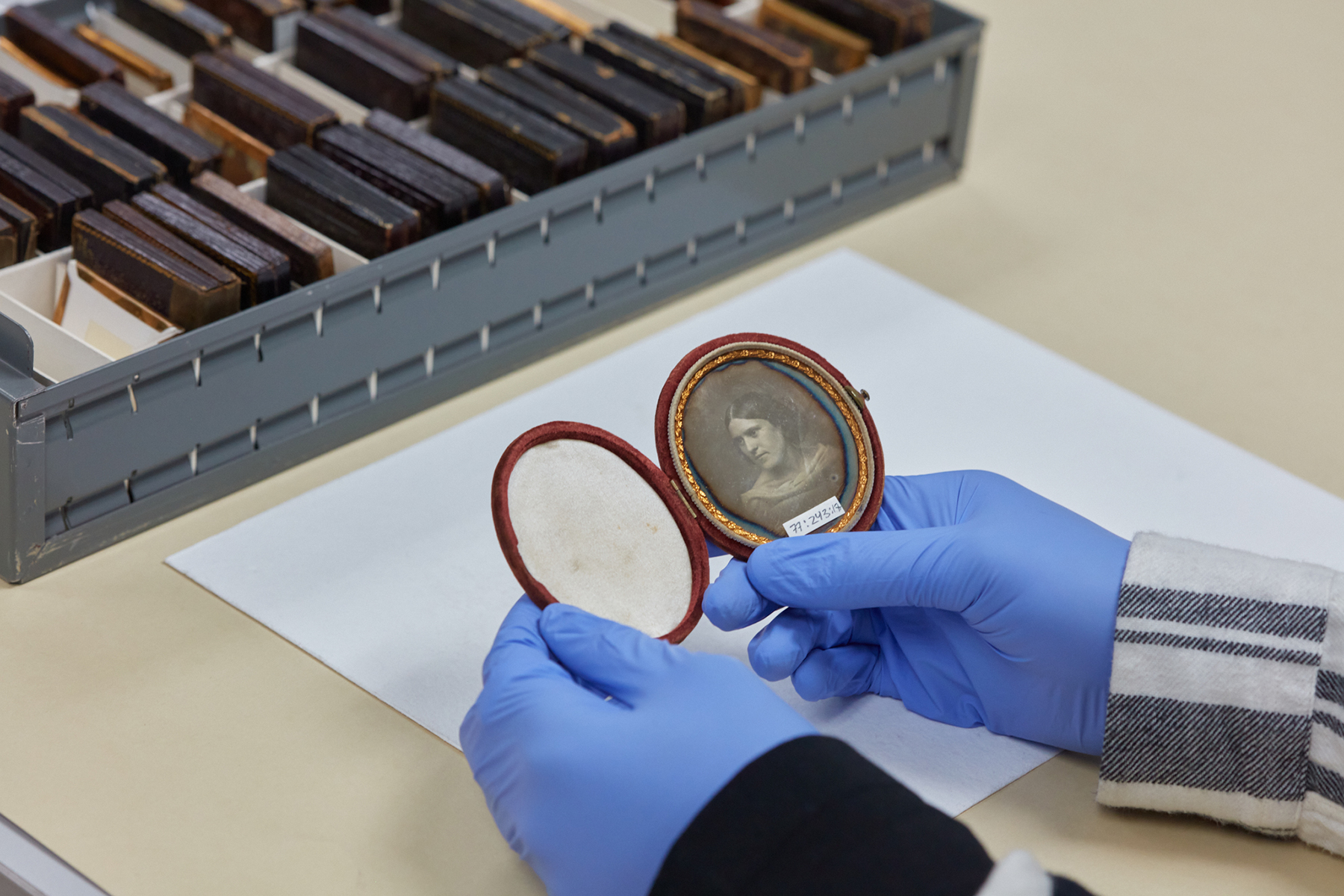 CR Smith holds a daguerreotype of an unidentified woman.