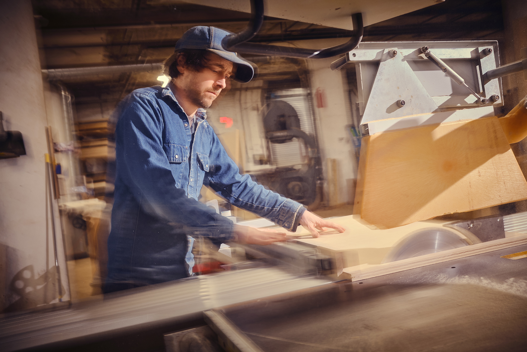 George Dubinsky works with a table saw.