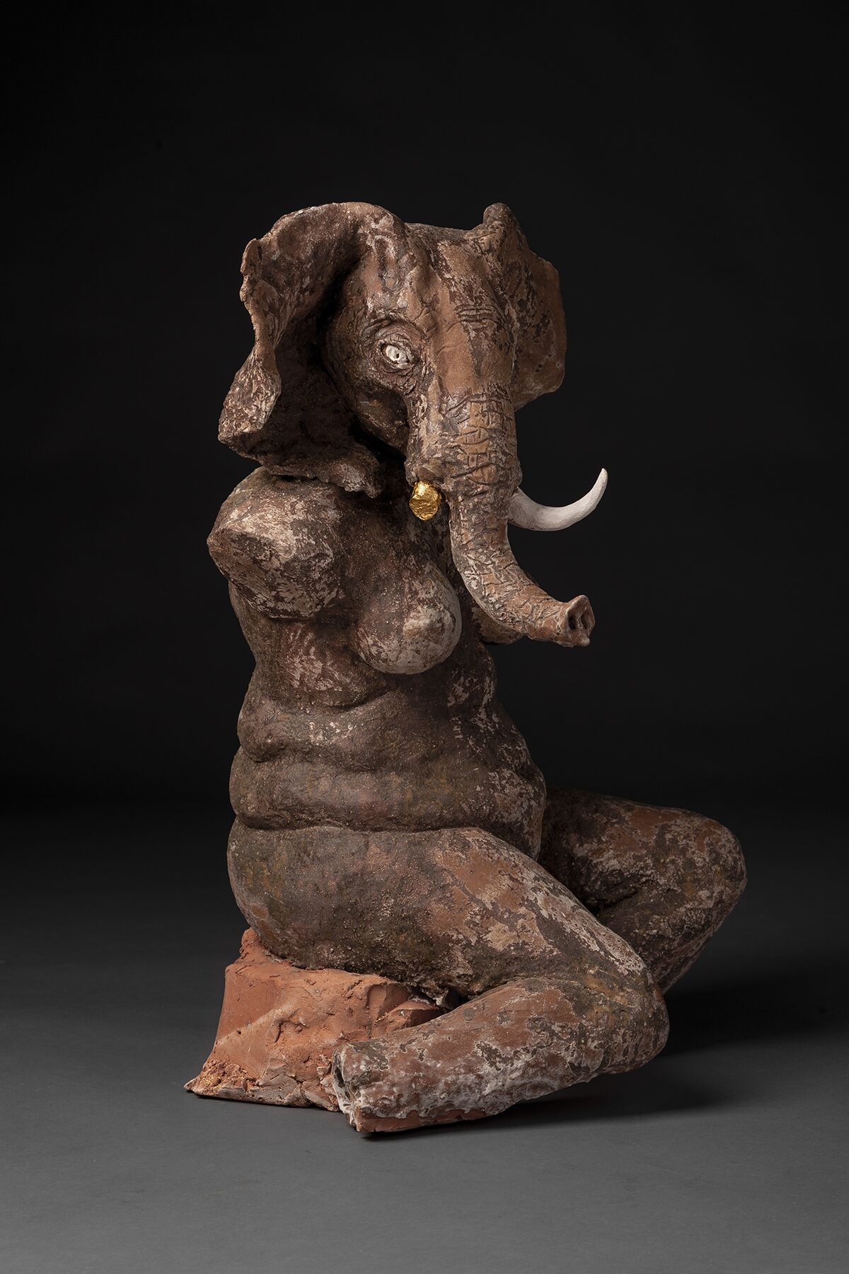 A sculpture of an elephant that represents a human-animal relationship.