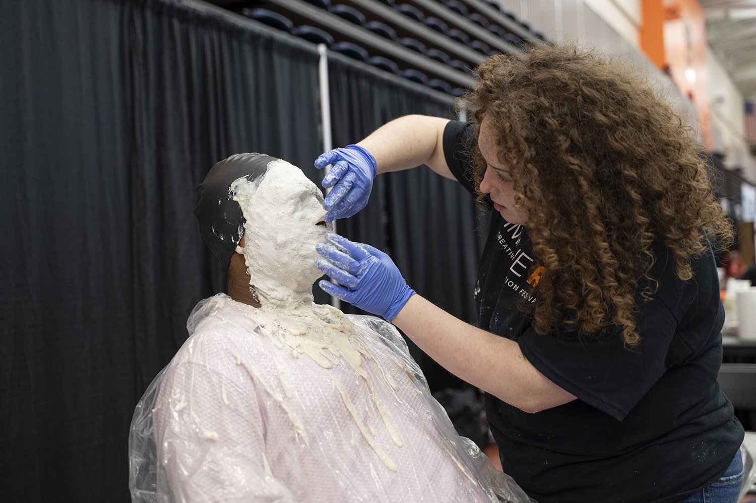 A student makes a facial casting of someone.