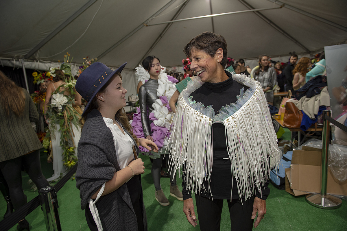 Nancy Munson backstage talking to a student before Fashion Week.