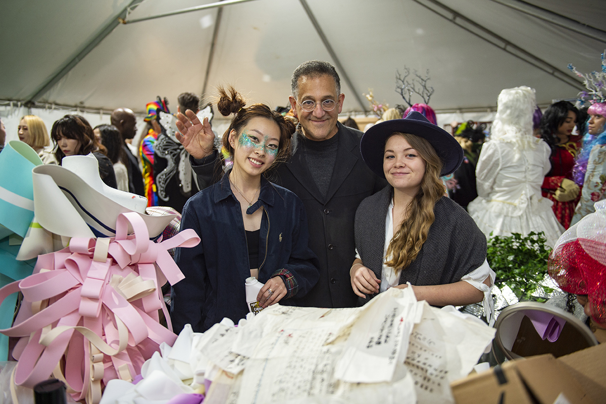 Faculty and students smile for a group photo before Fashion Week.