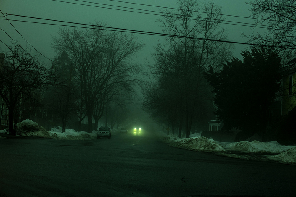 Cars in a street with a green tint
