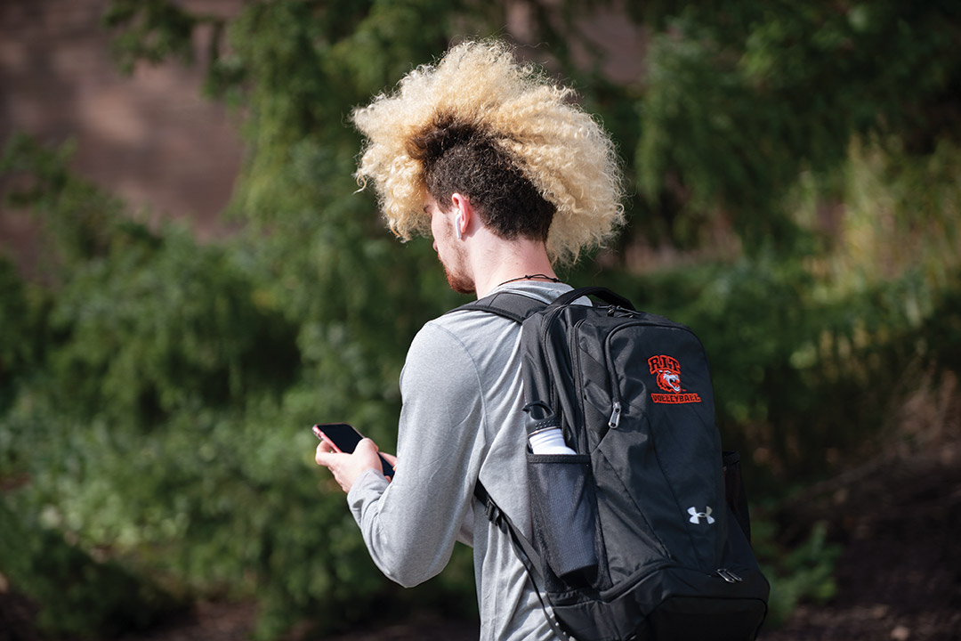 student with brunette hair and a long, blonde mohawk hair style.