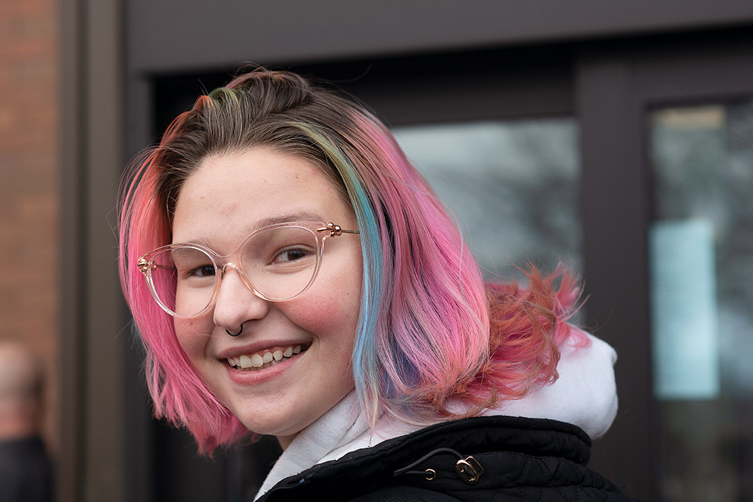 student with pink and blue hair.