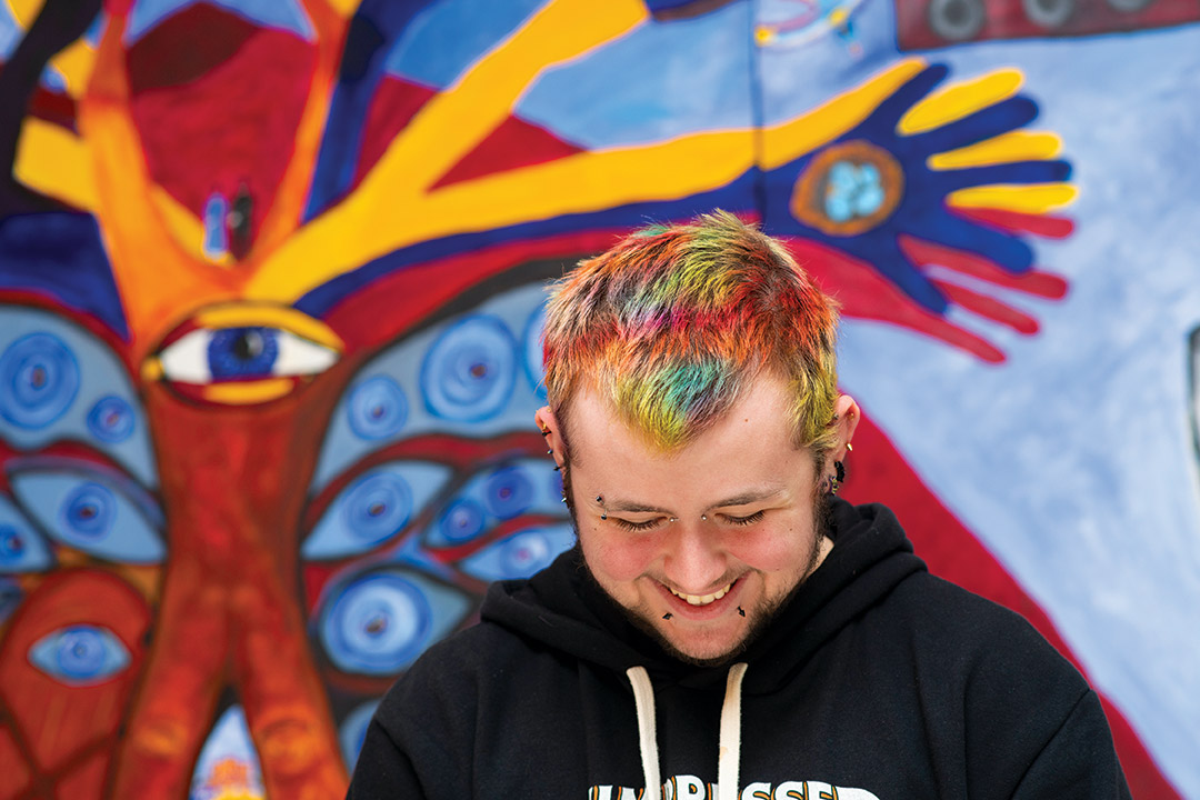 student with short hair dyed many colors.