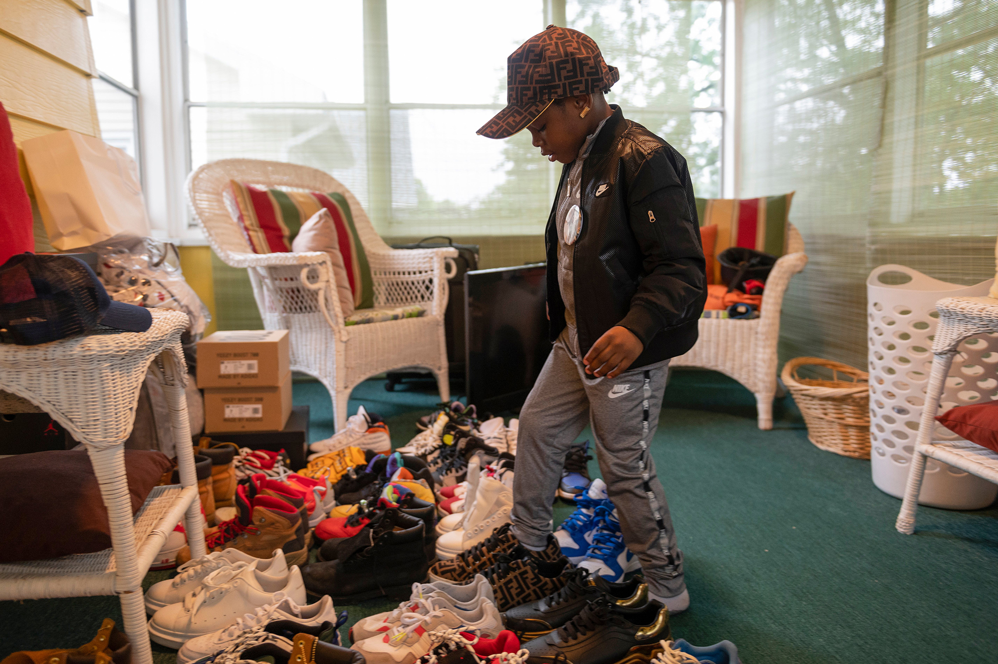 8-year-old Jamma tries on the sneakers of his late father.