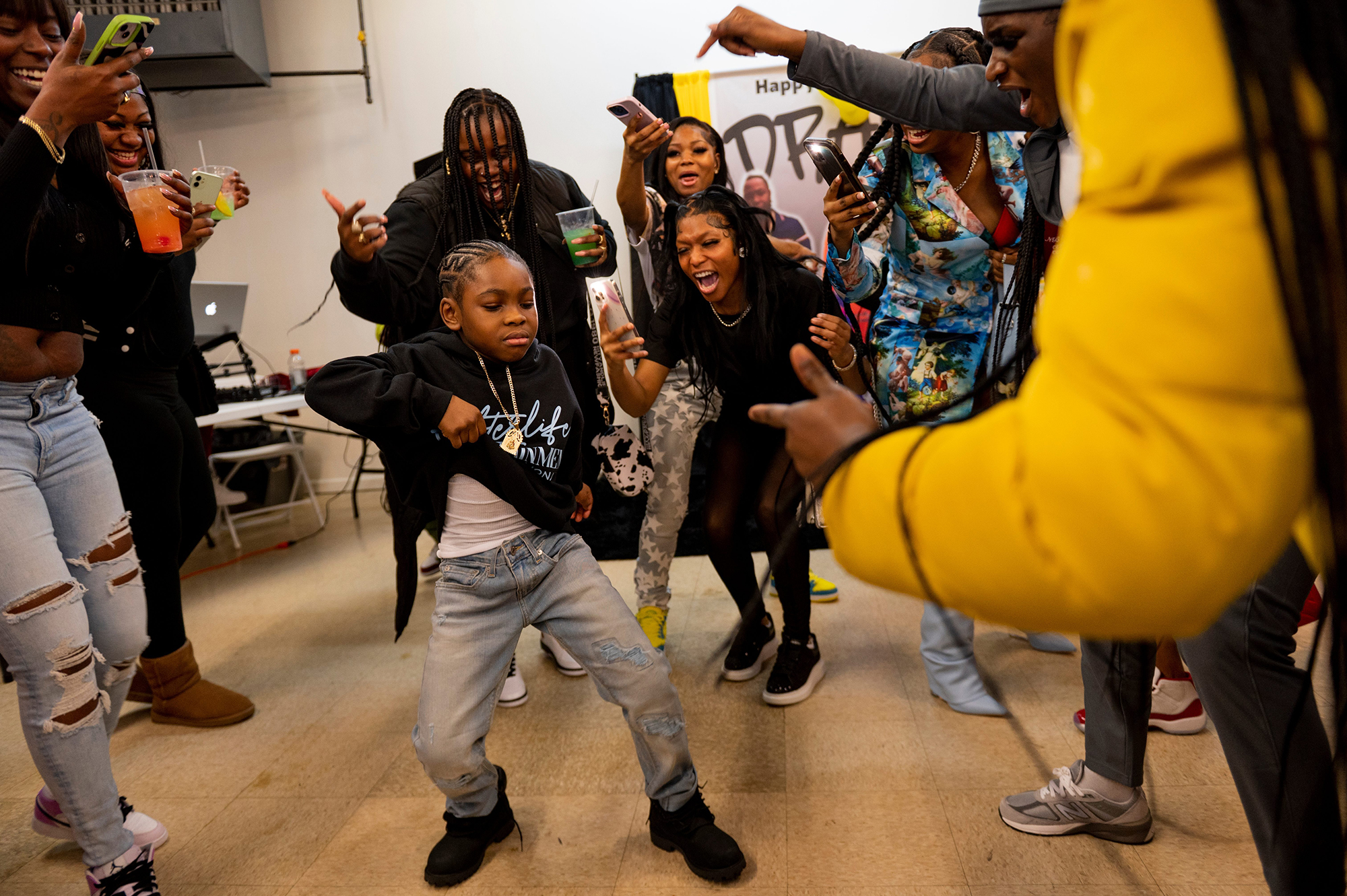 Jamma, 8, dances as friends and family happily look on.