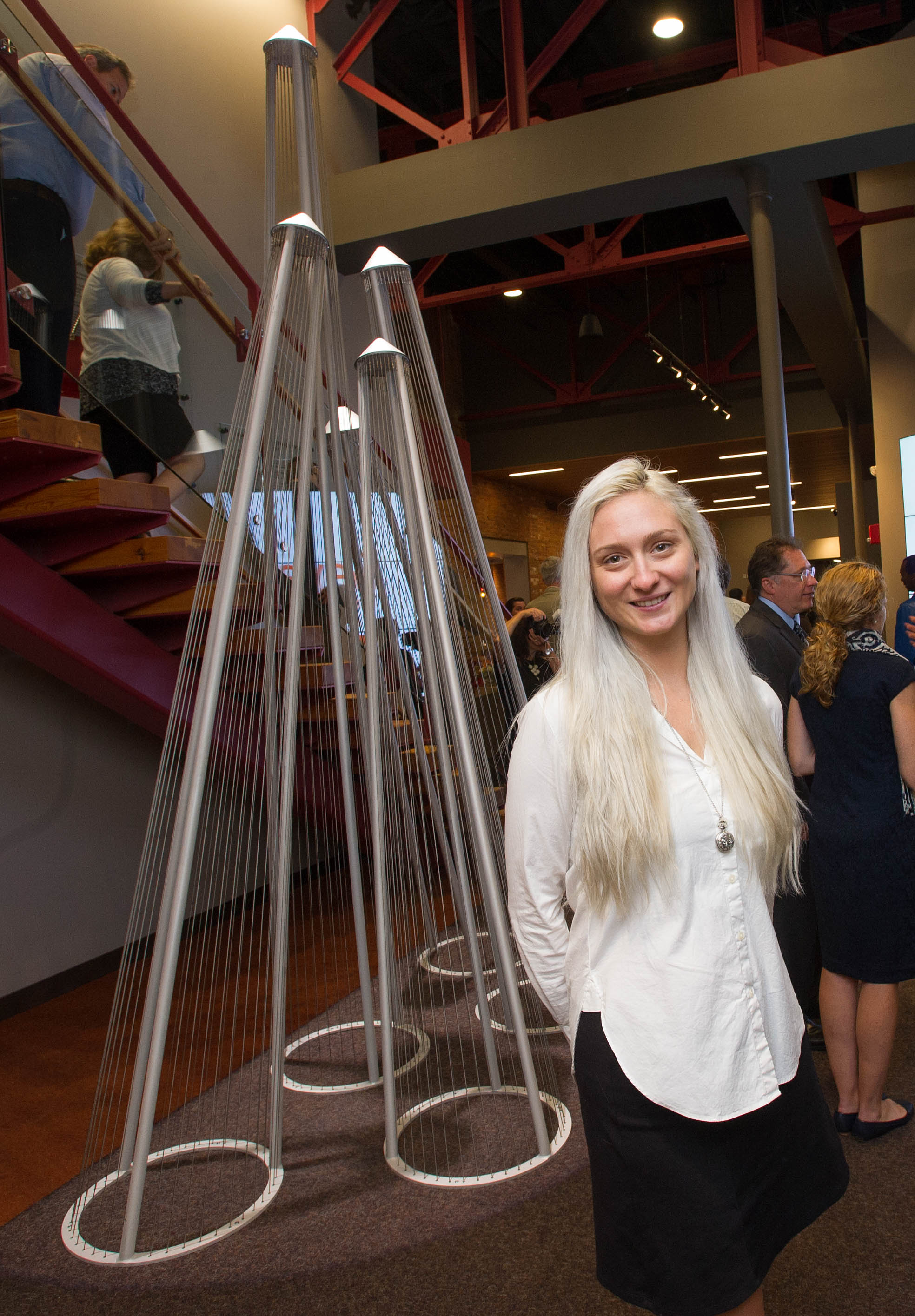 Julia Manson with her sculpture in the Geva Theatre lobby in 2016.