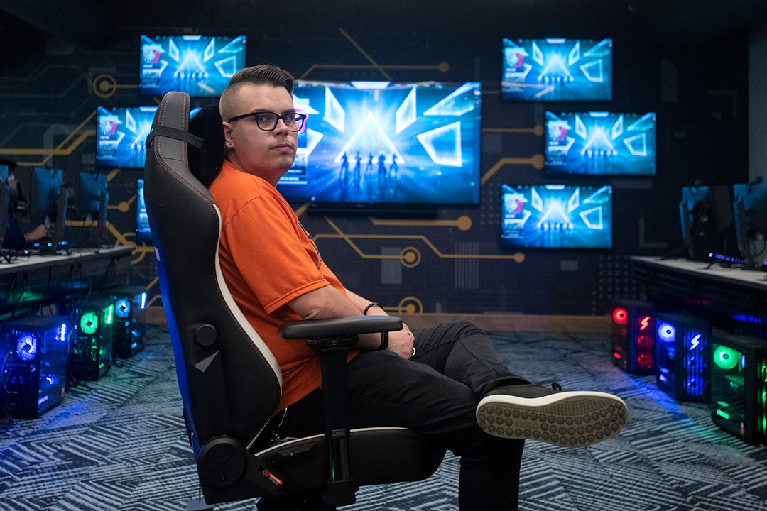 person sitting in a gaming chair in a lounge.