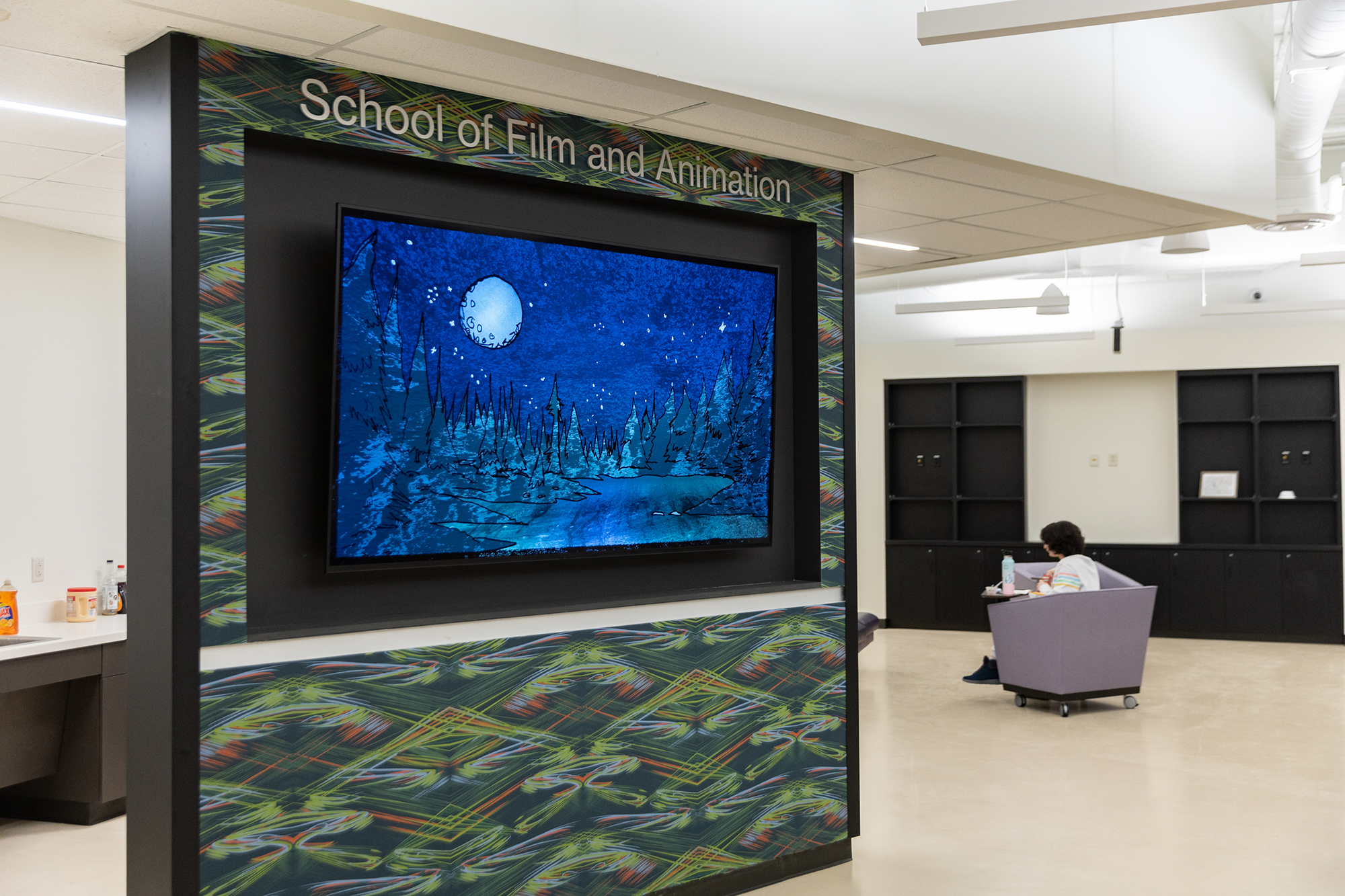 A lobby area with a screen full of content.