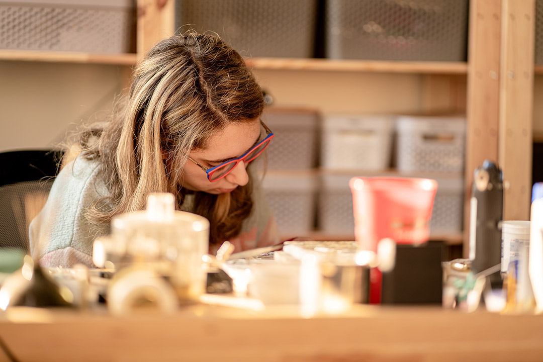 person making jewelry.