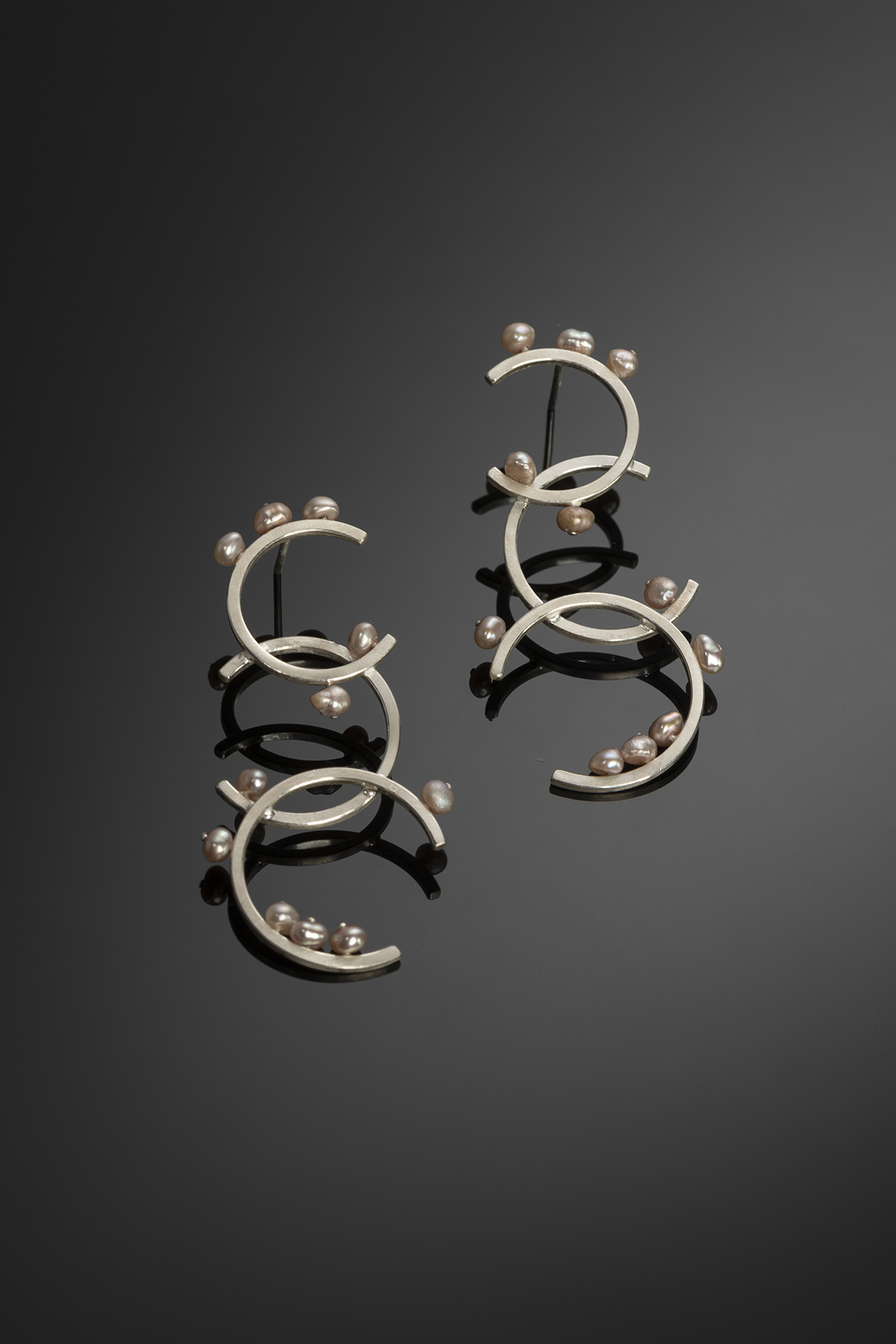 Sterling silver and pearl hoop earrings.