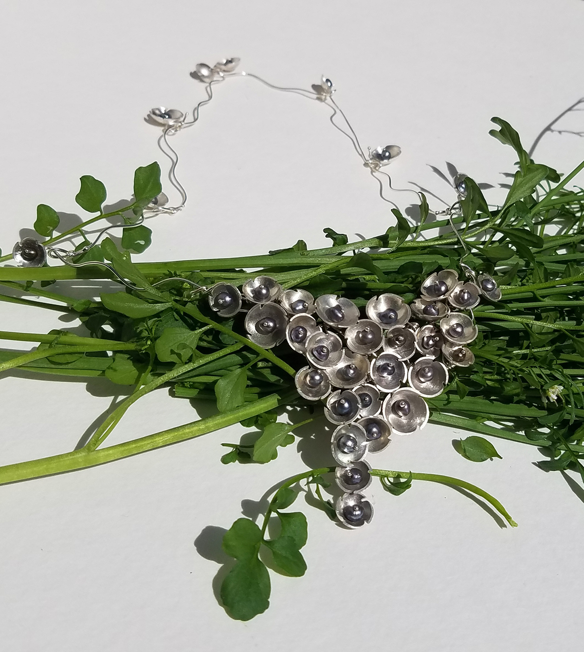 A necklace tied to a bouquet of flowers.