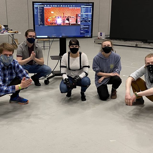 A group of students pose for a photo on the set on motion capture filming.