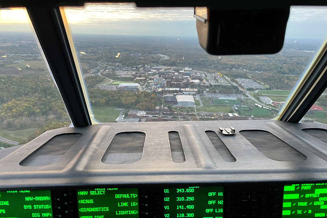 aerial view of a college campus from the front of a cargo plane in air.