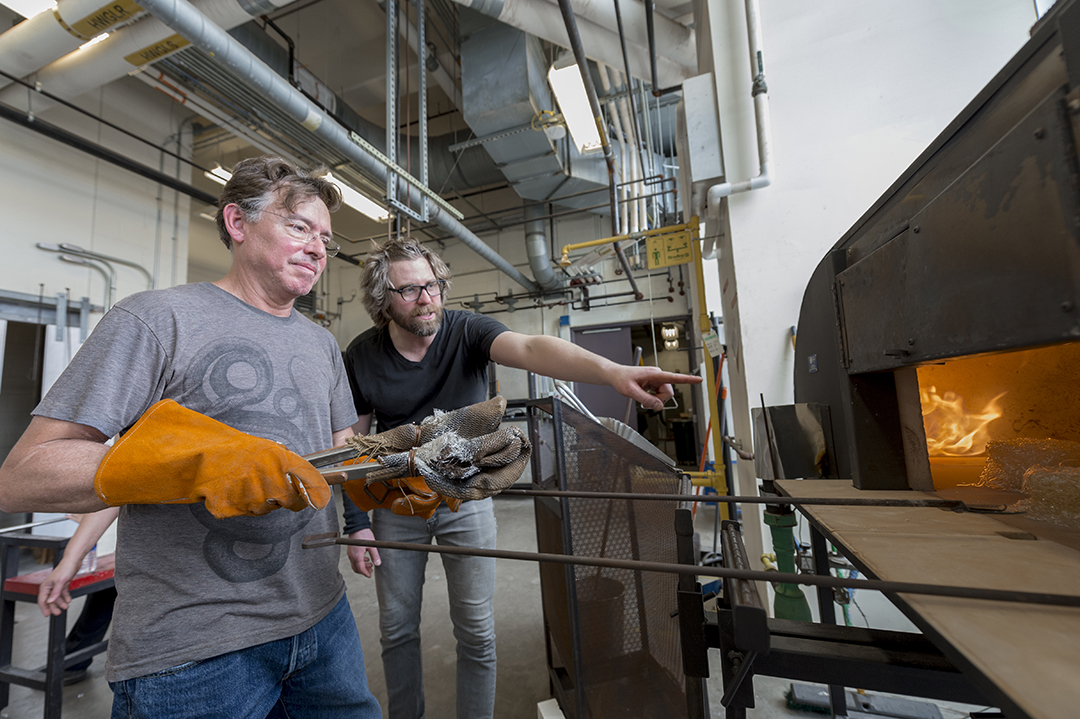 Peter Houk and David Schnuckel work together in the hot shop