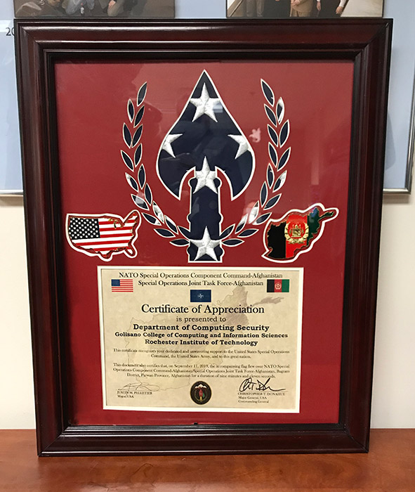 Framed plaque reads: Certificate of Appreciation presented to Department of Computing Security.
