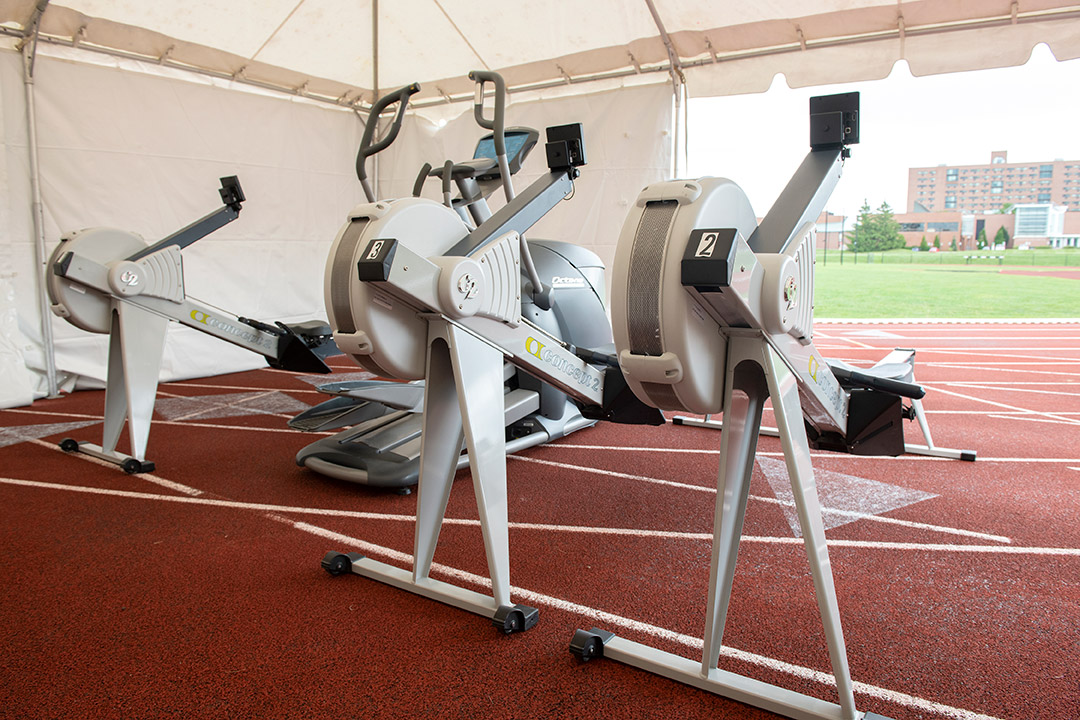 four exercise machines in a tent.
