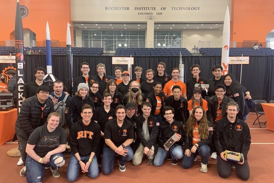 team of more than 20 college students posing for a photo.