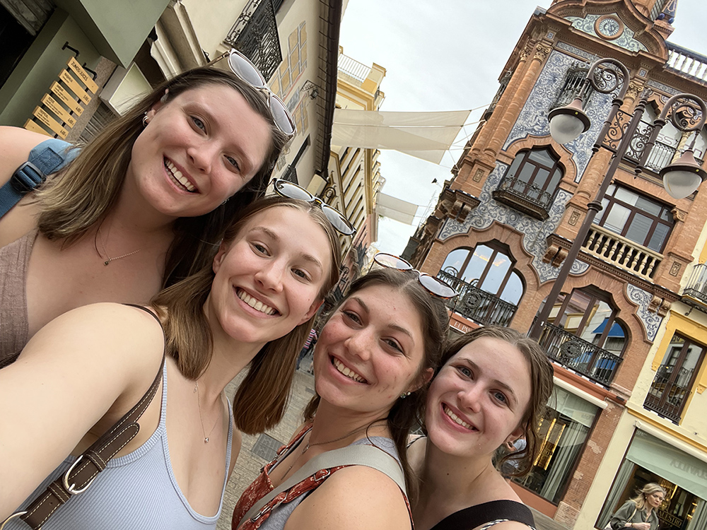 Four roommates take a selfie in Spain.