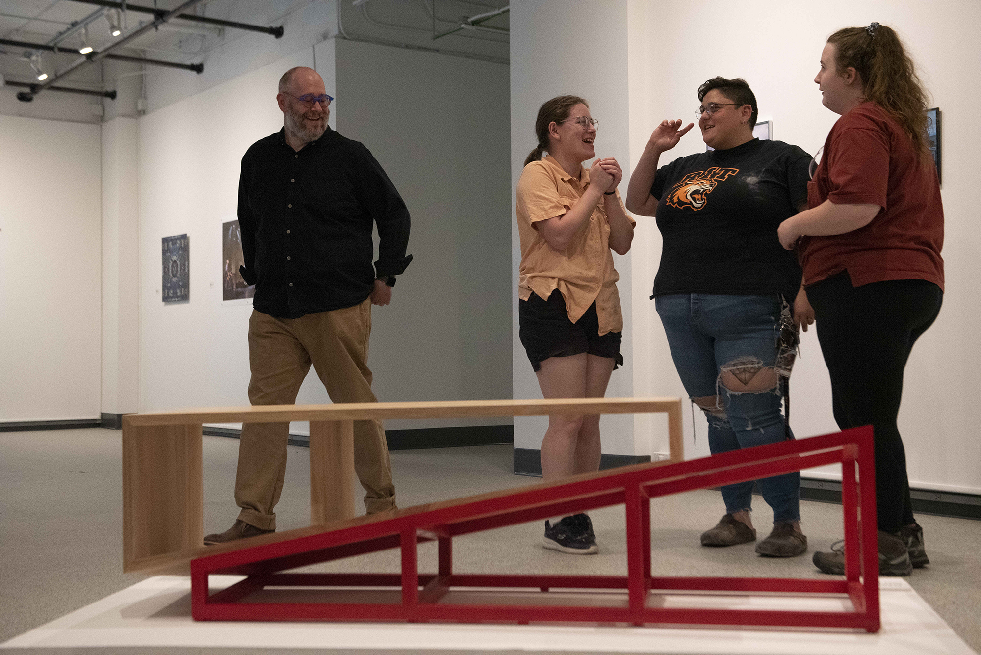 Mitch Goldstein and students look at a bench he designed.