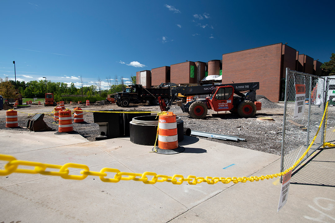 a brick building in the background and construction in the foreground.