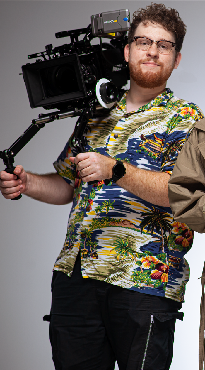 A portrait of Simon Yan with a camera.