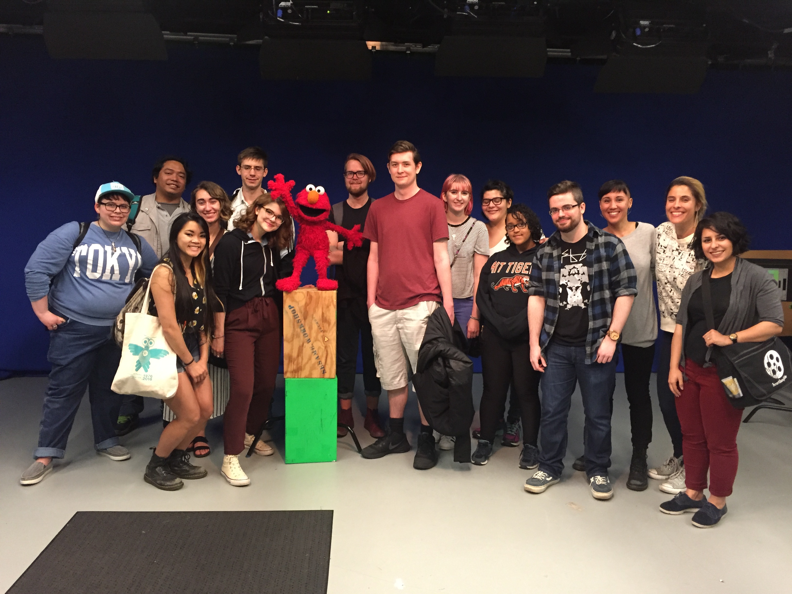 A group of SOFA students taking picture in an studio with Elmo from Sesame Street.