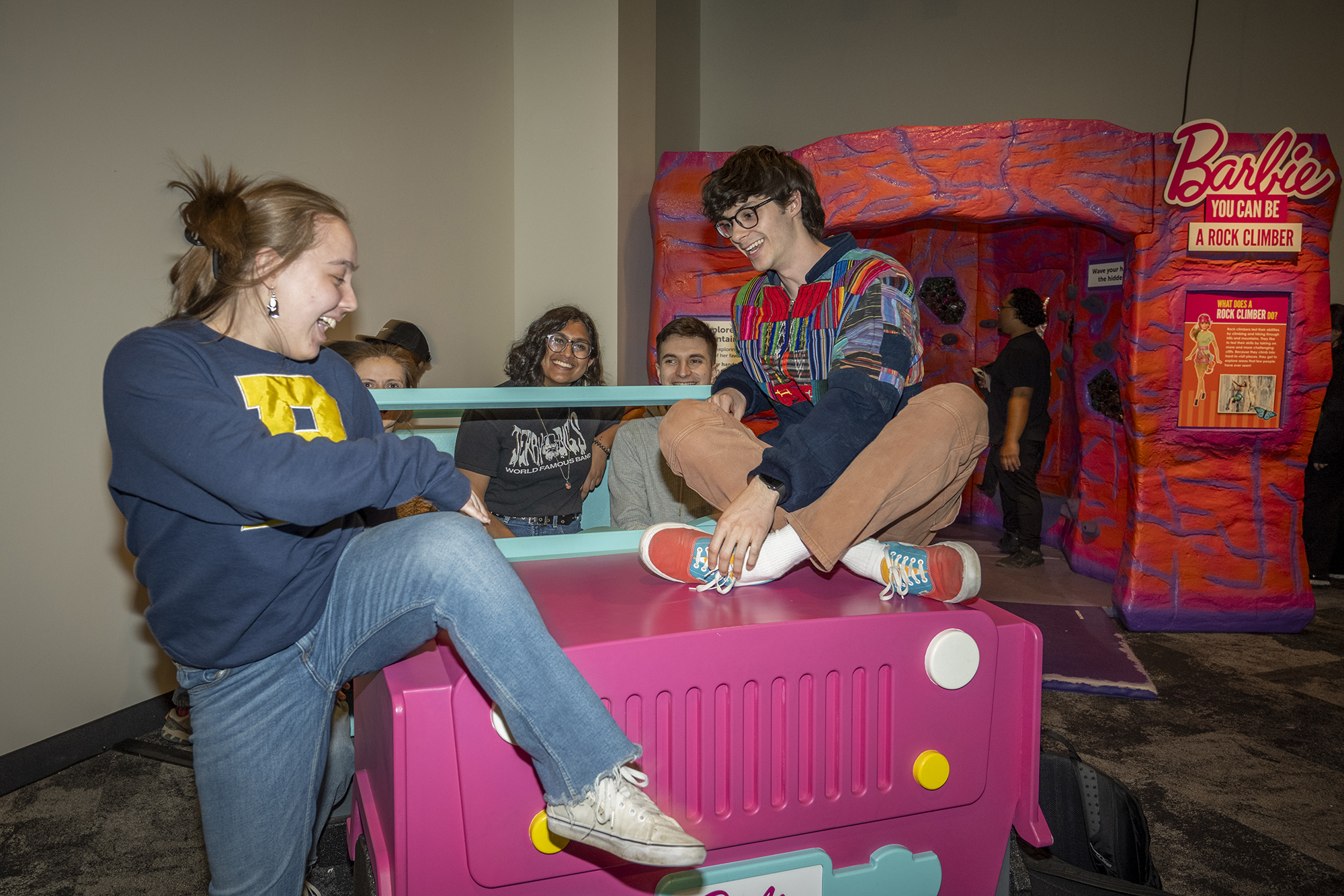 A group of students engage with the Barbie exhibit at the Strong National Museum of Play.