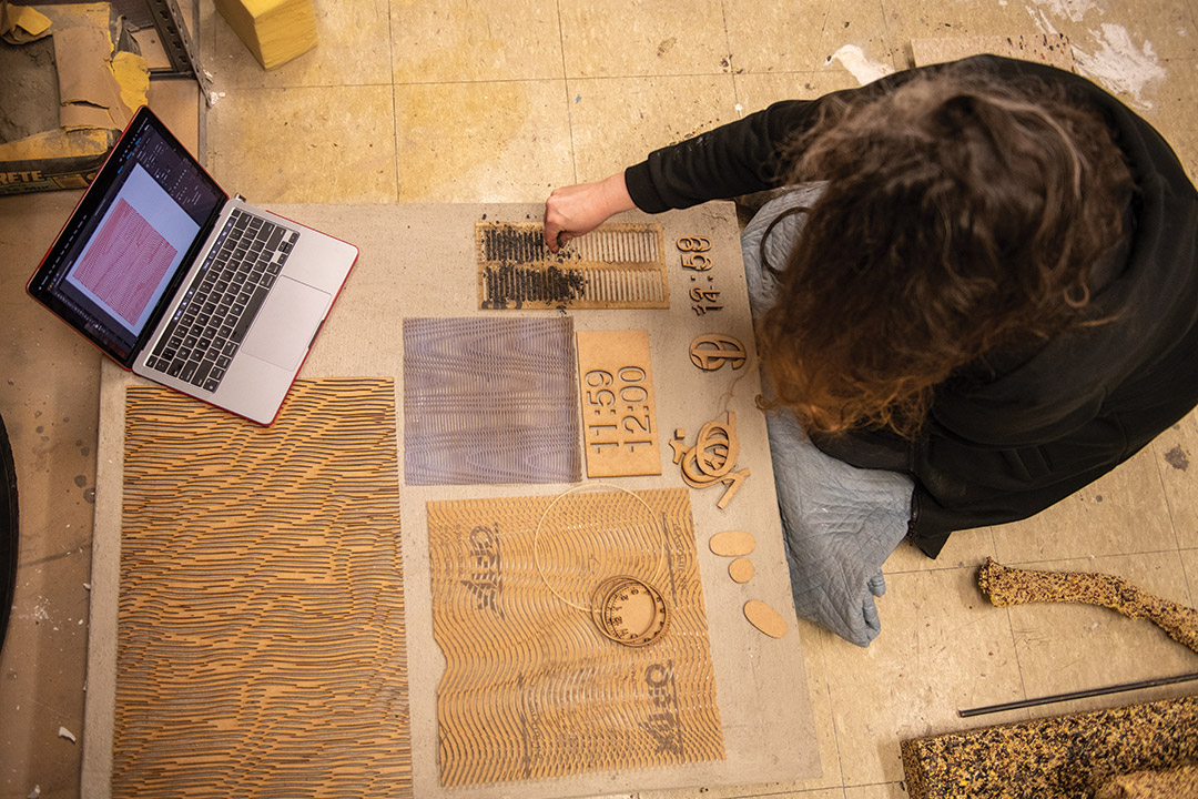 student working with laser-cut letters and numbers.