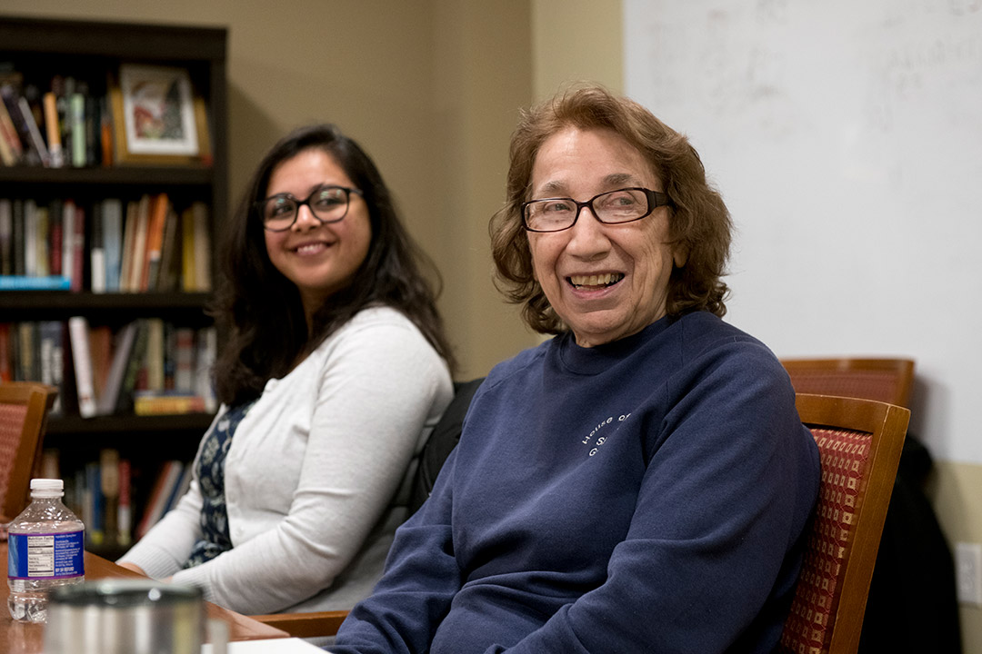 student and nun sitting next to each other.