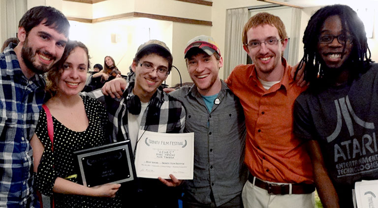 The group of students holding their award