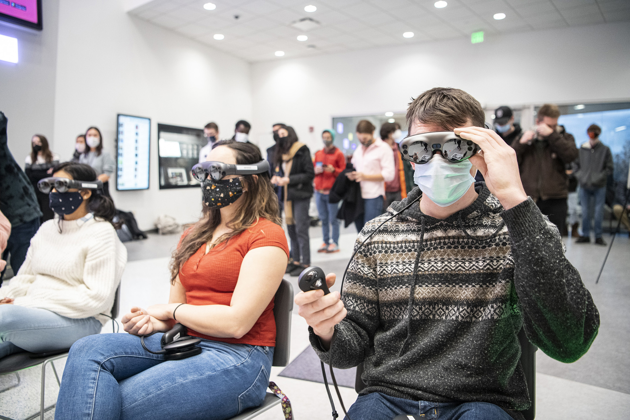 A row of people wearing VR headsets.