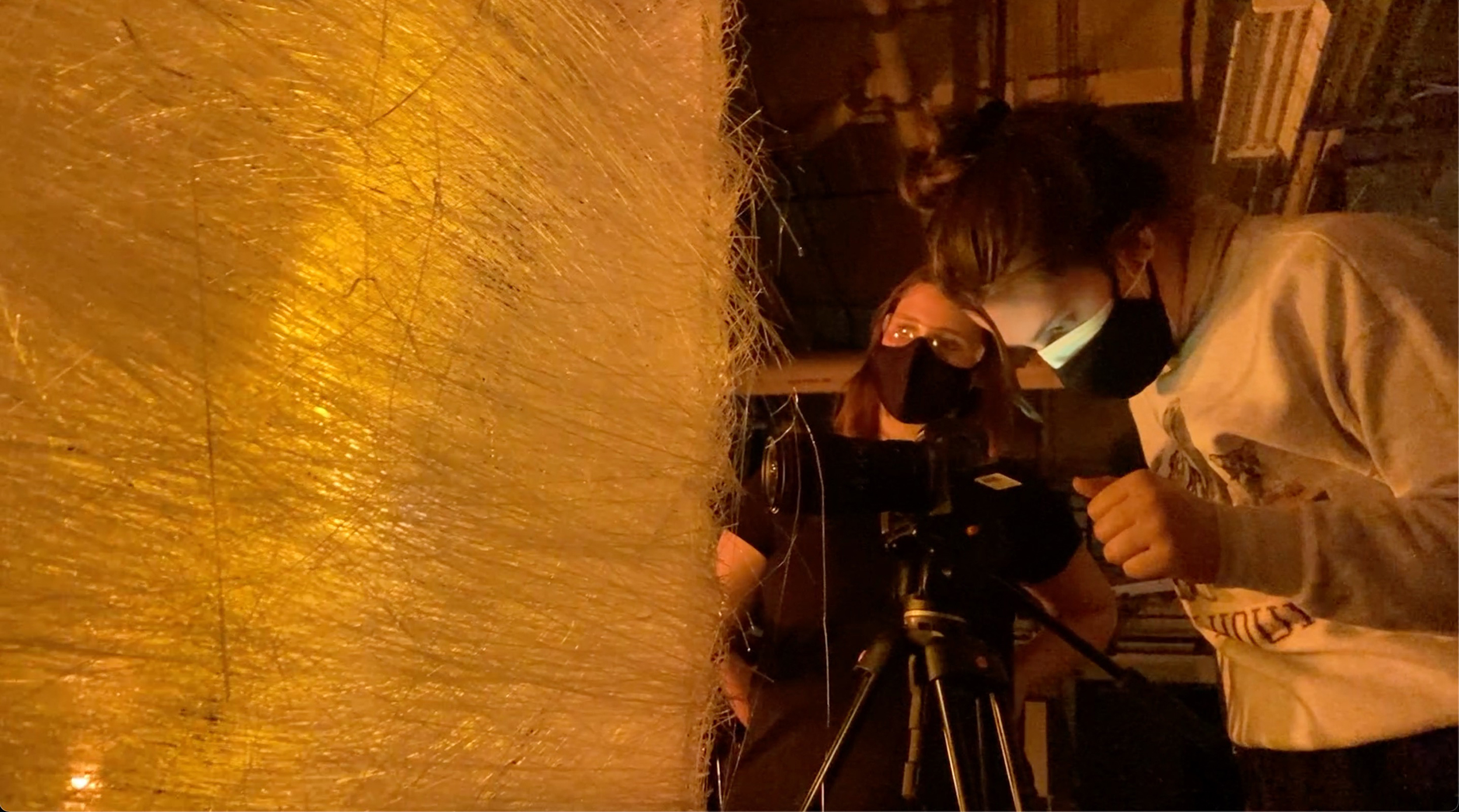 Trisha Pickelhaupt operates a camera to capture a large glass structure.