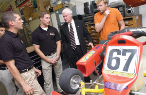 RIT President, Faculty and Students discussing Formula Car