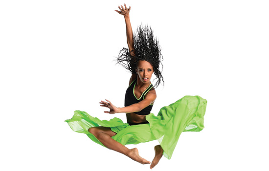 Dancer jumping in green skirt.