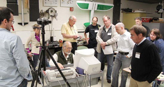 People surrounding Person using computer