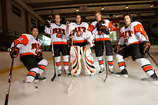 Hockey players posing for camera