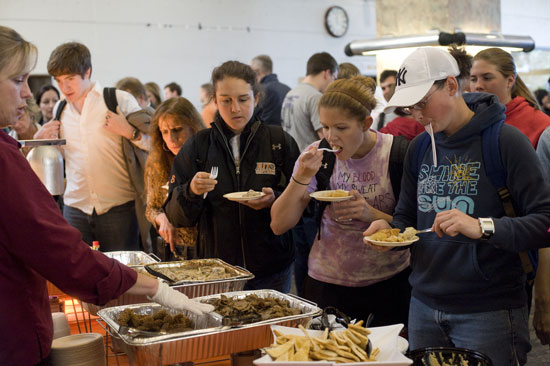 People trying food at event