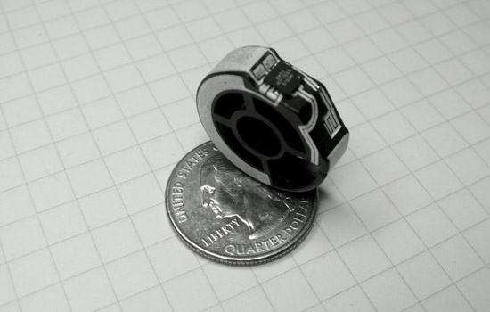 a round device sitting on top of a quarter.