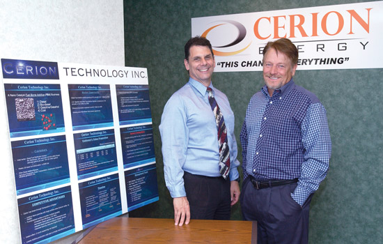 Alumni and person posing by "Cerion Energy" displays
